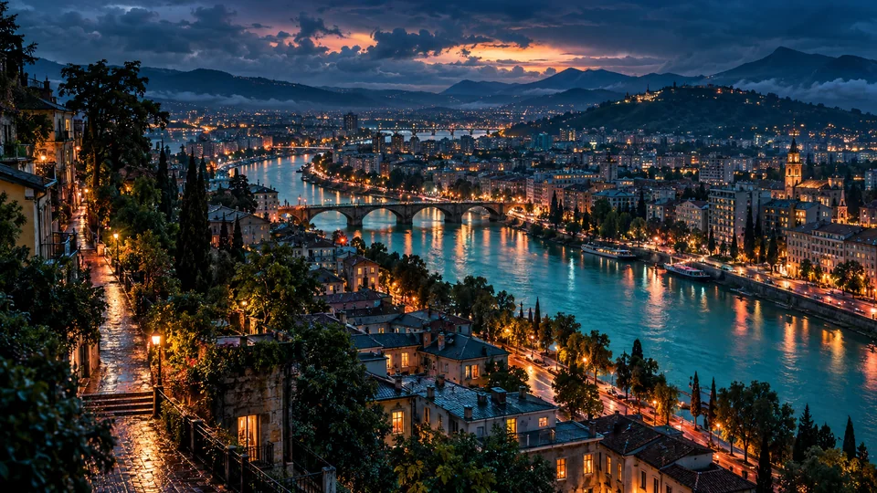 An imagined river city after rain, with lit windows and a bridge beneath a clearing sky.